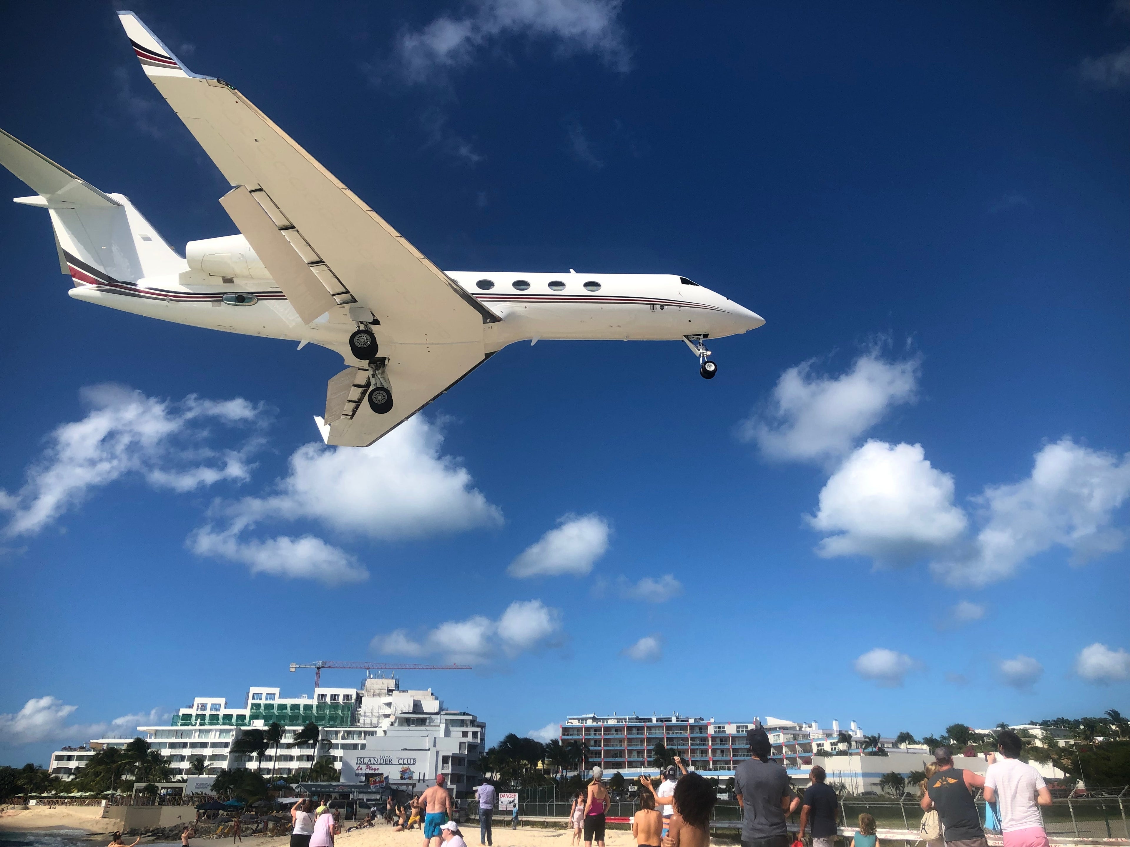 Plane flying over beach by Erin Carey