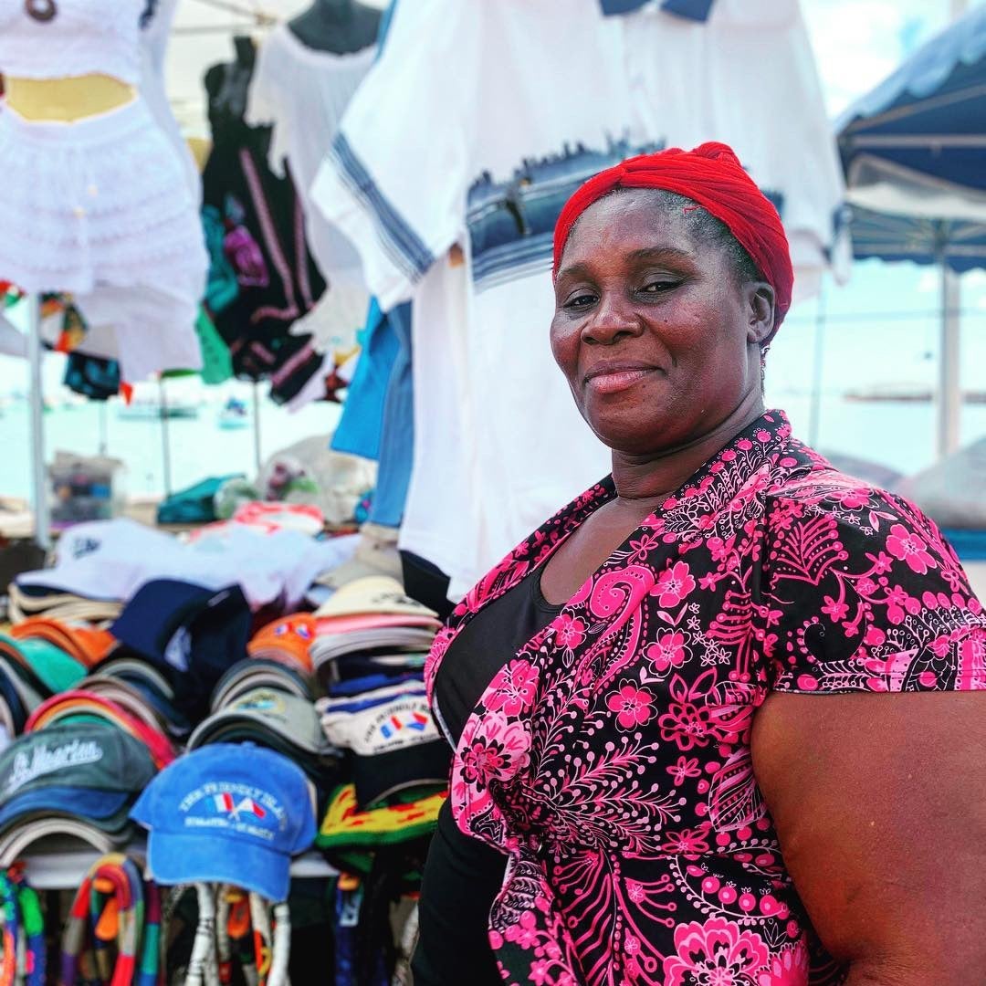 Woman in front of her market stall by Erin Carey