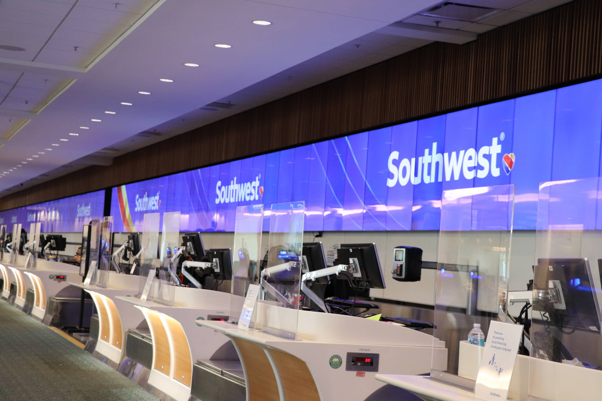 Plastic protective barriers are now in place at check-in counters at Orlando International Airport, including for Southwest. (Image courtesy of Orlando International Airport)