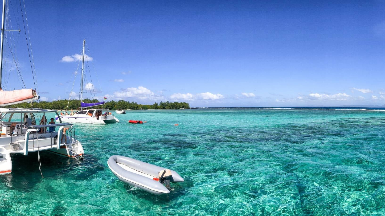 Catamarans anchored near a beautiful beach