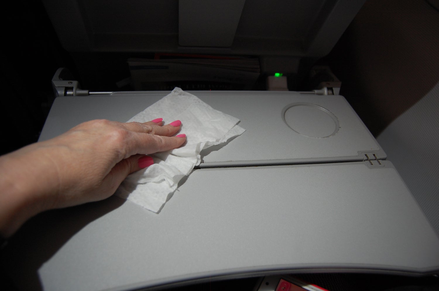 Person cleaning airline table