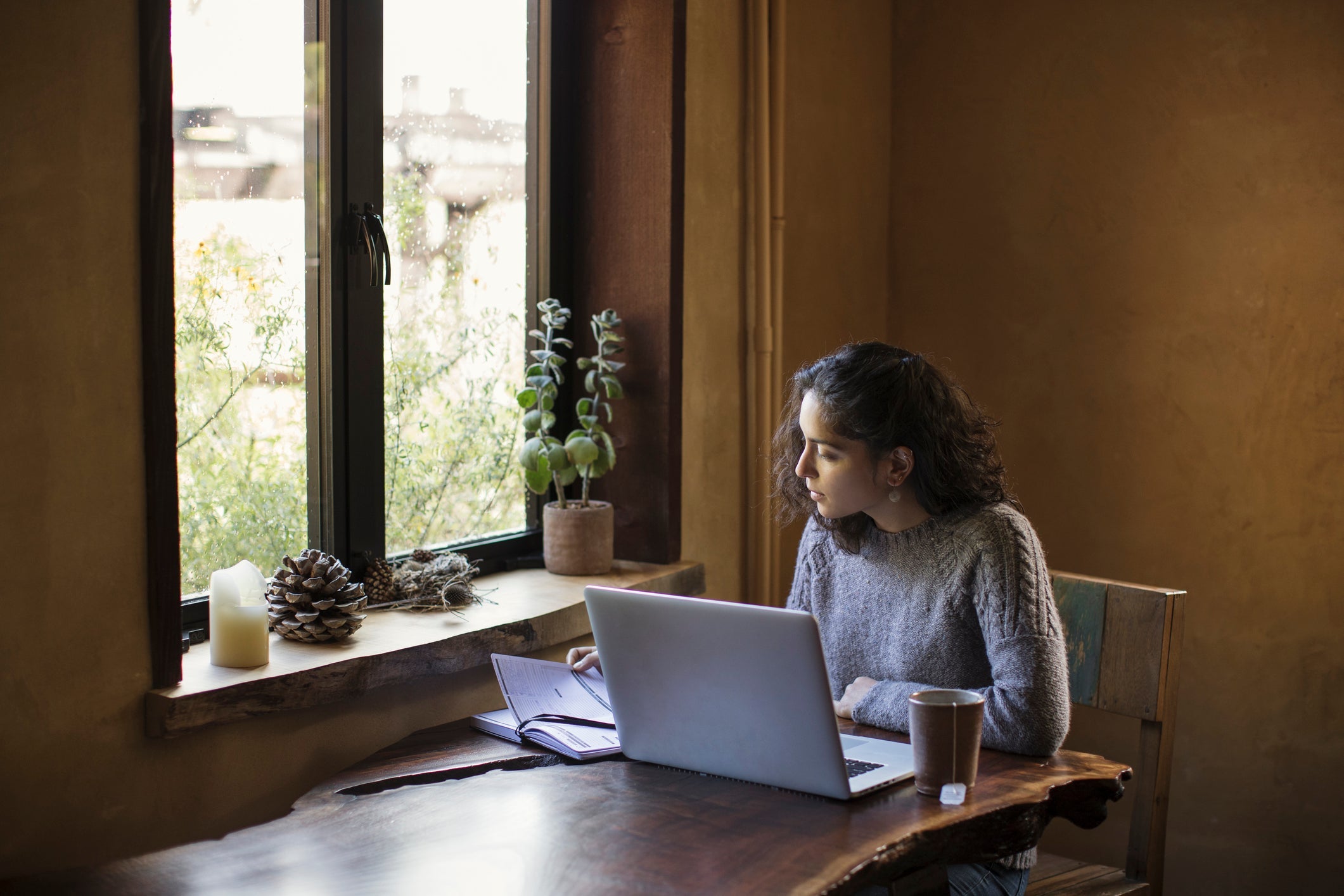 Woman sitting at desk by window working