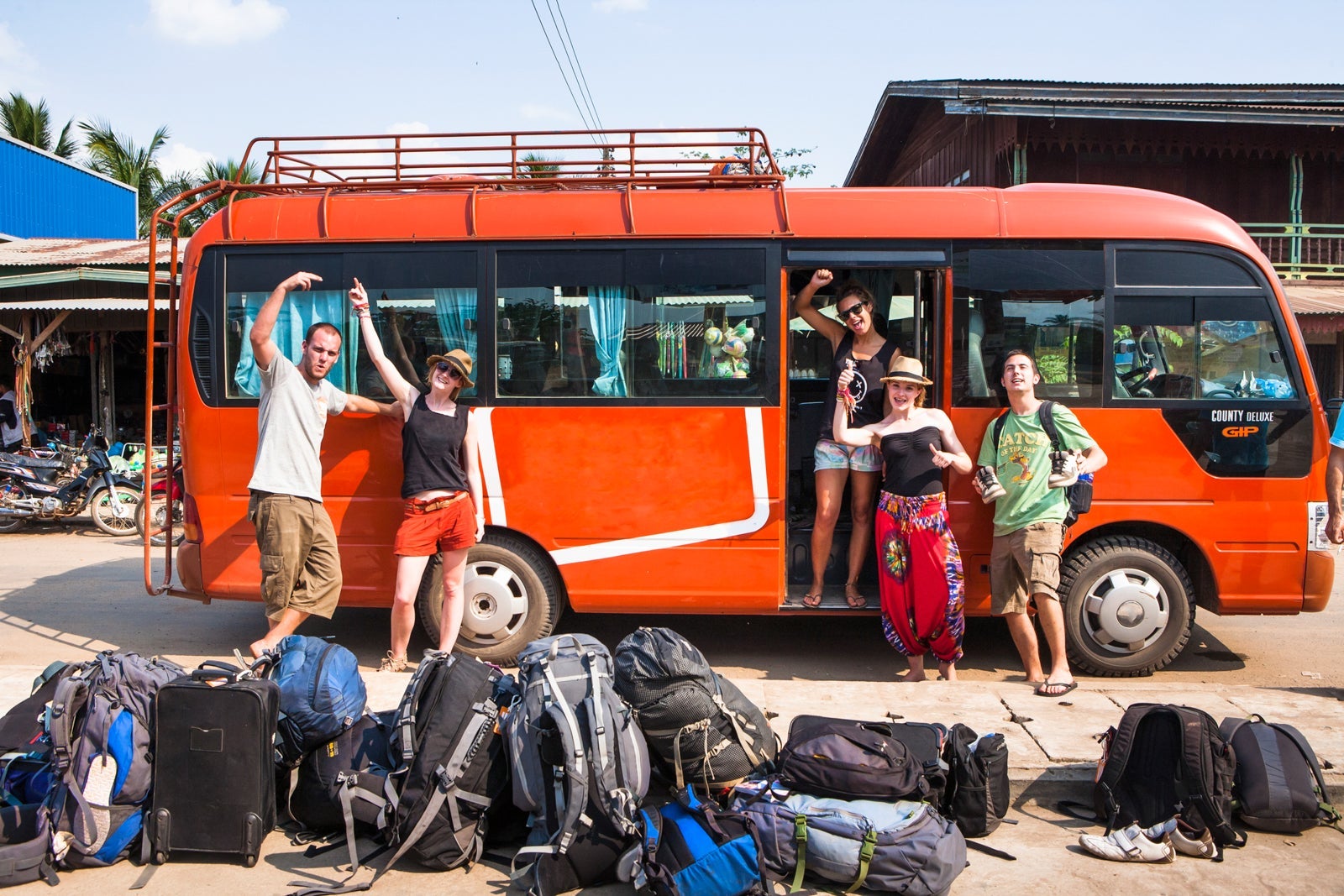 Backpackers wait for their tour bus to depart.