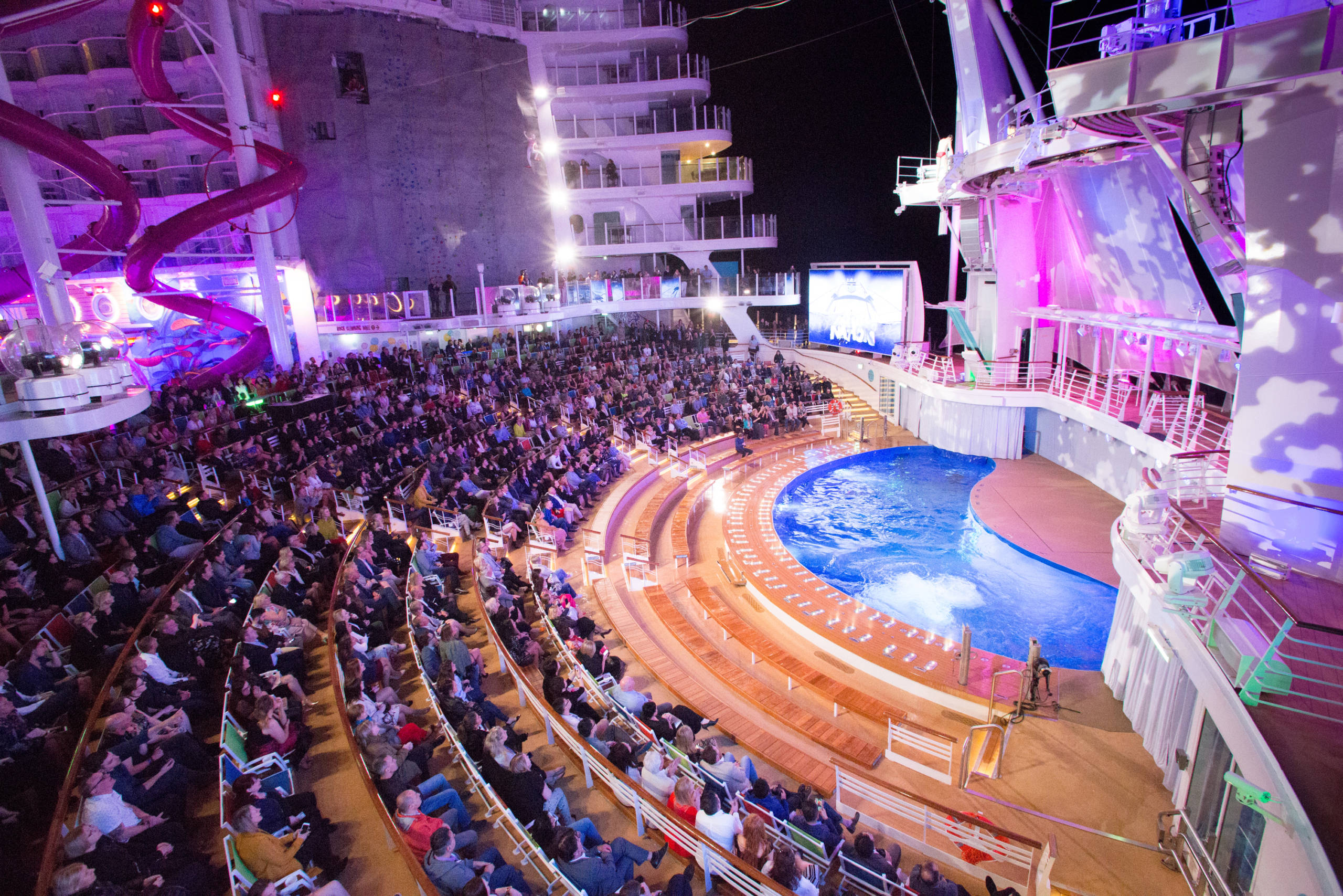 Semi-circle seating facing a stage and high-diving pool