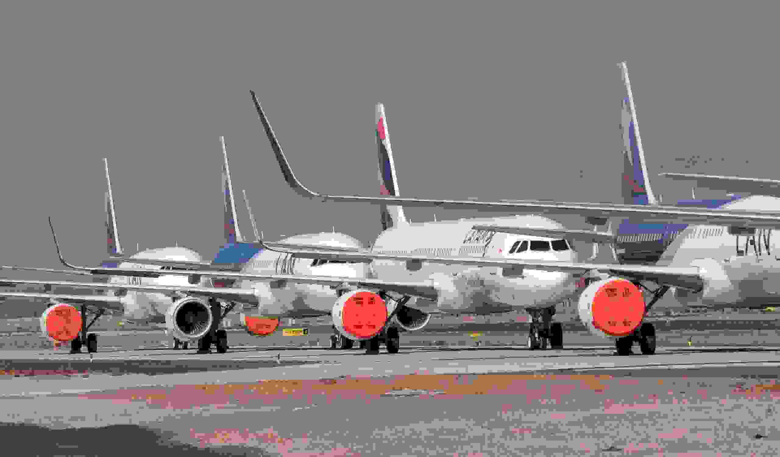 Aircrafts of Latam airline sit on the tarmac at Santiago International Airport, in Santiago, on April 20, 2020 during the new coronavirus, COVID-19, pandemic. - Latin America's biggest airline, the Brazilian-Chilean group LATAM, announced last Friday that the 95% reduction of its passenger operations announced in April will be extended until May due to the coronavirus crisis, which will cause a deeper impact than expected. (Photo by MARTIN BERNETTI / AFP) (Photo by MARTIN BERNETTI/AFP via Getty Images)