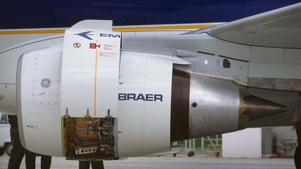 Engineers inspecting inside the open engine cowling
