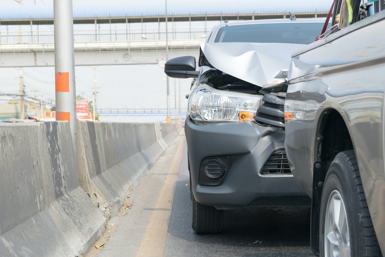 photo shows the damaged front of a car after hitting another vehicle in front of it