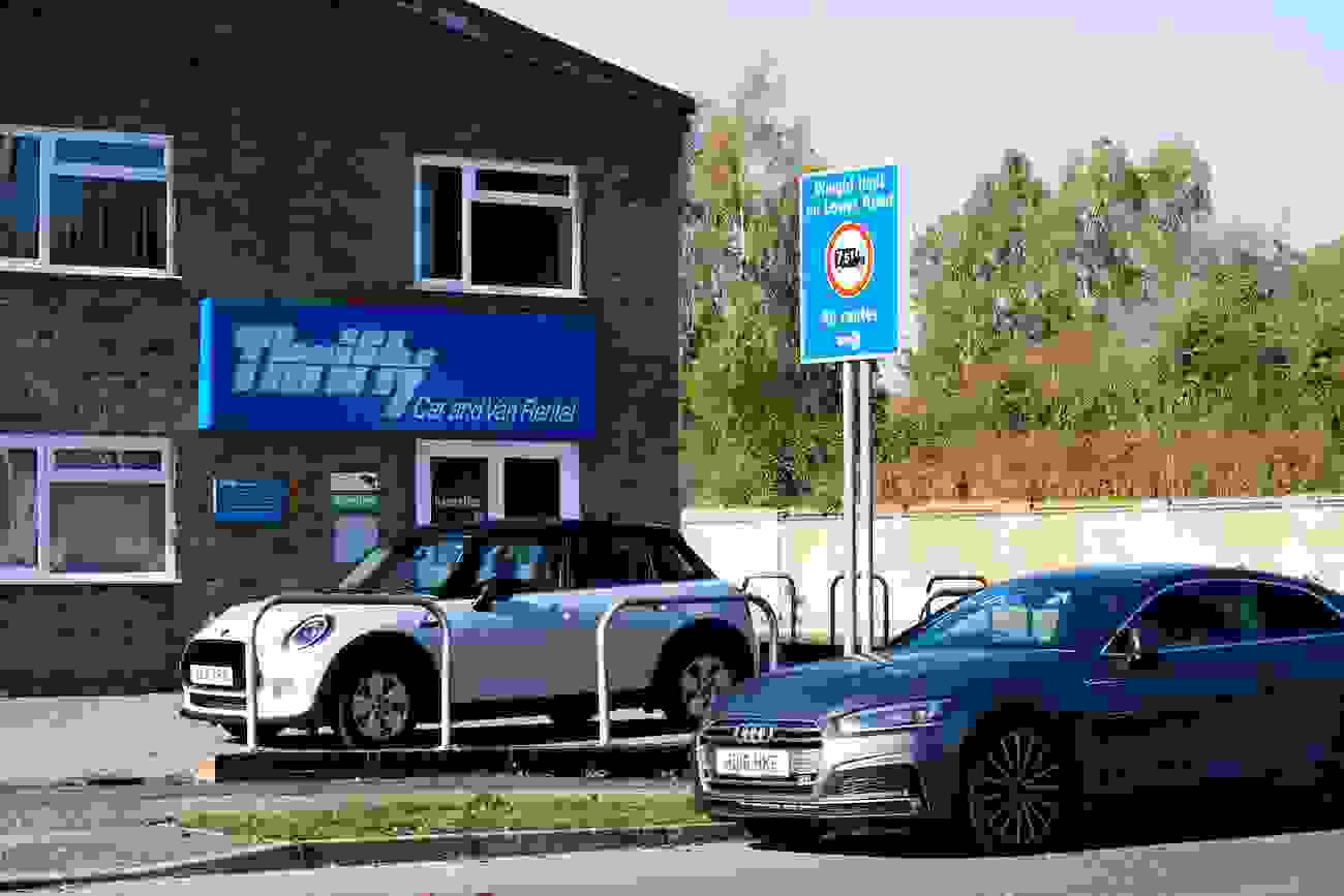 Thrifty car rental storefront with two cars outside