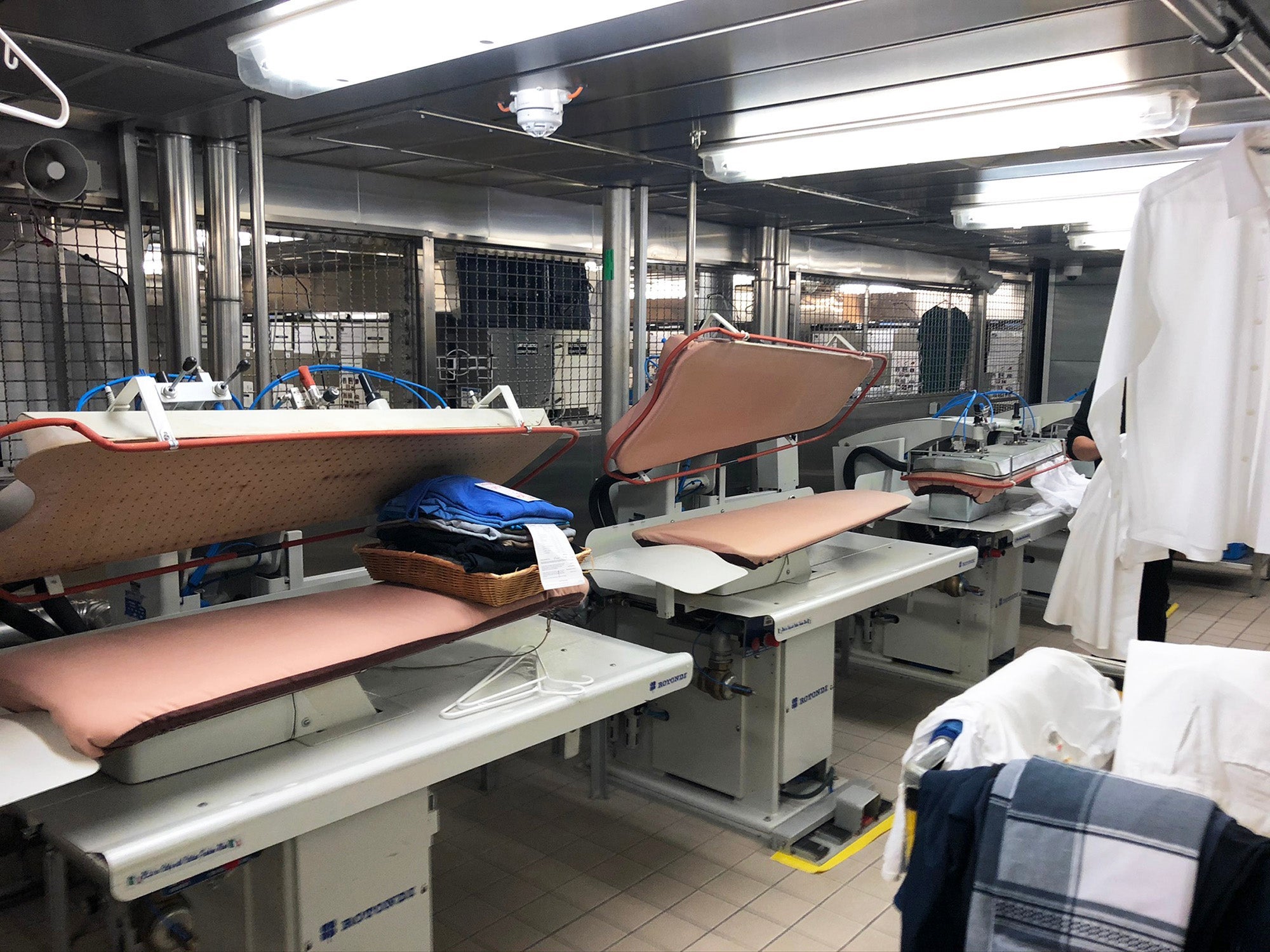 Two large pressing stations below deck in the crew laundry on a cruise ship