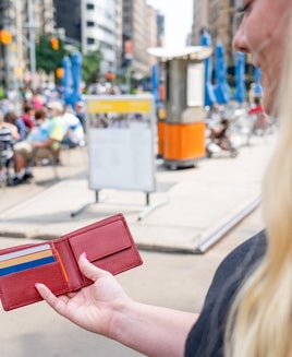 woman holding open bifold wallet