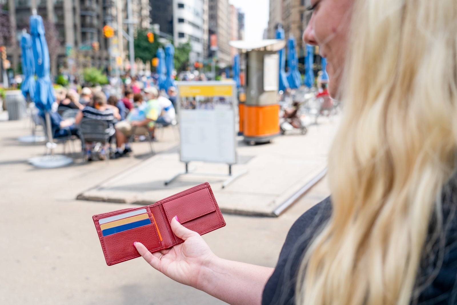 woman holding open bifold wallet