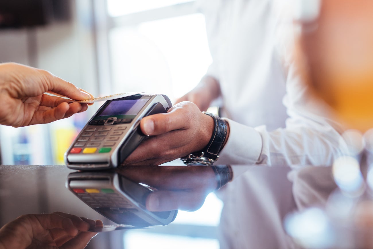 Person Tapping to Pay with Credit Card