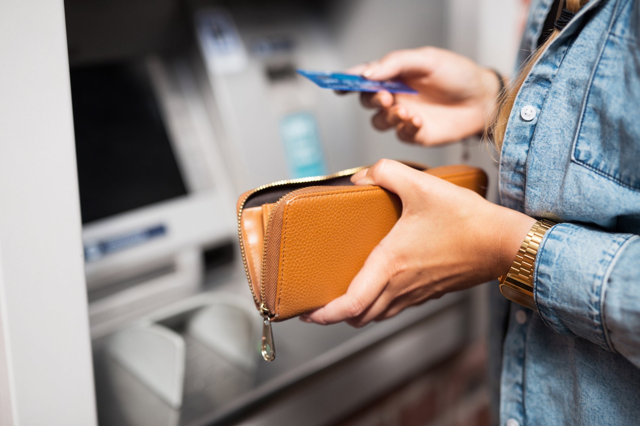 A woman takes money from ATM