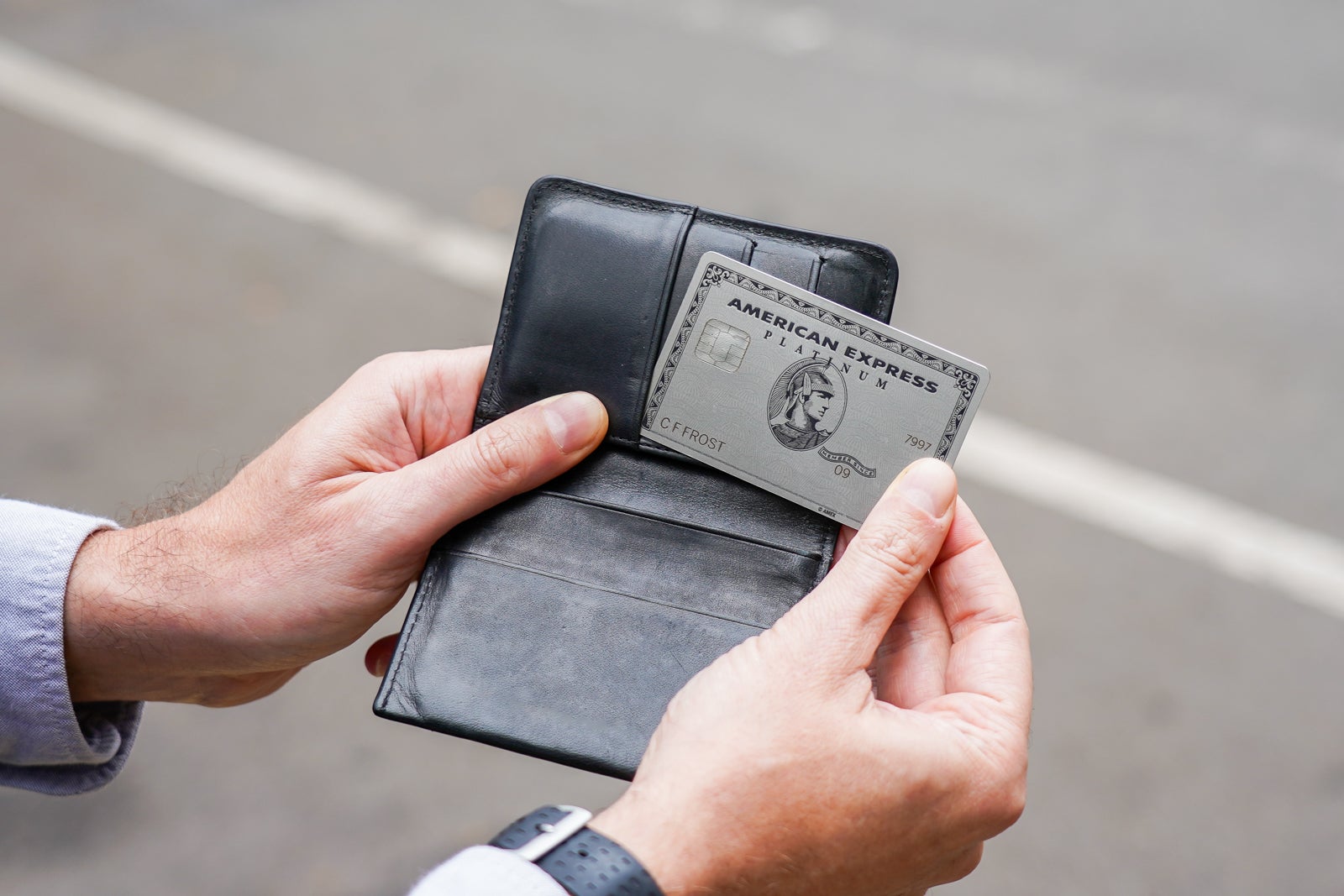 Amex Platinum in wallet on city street