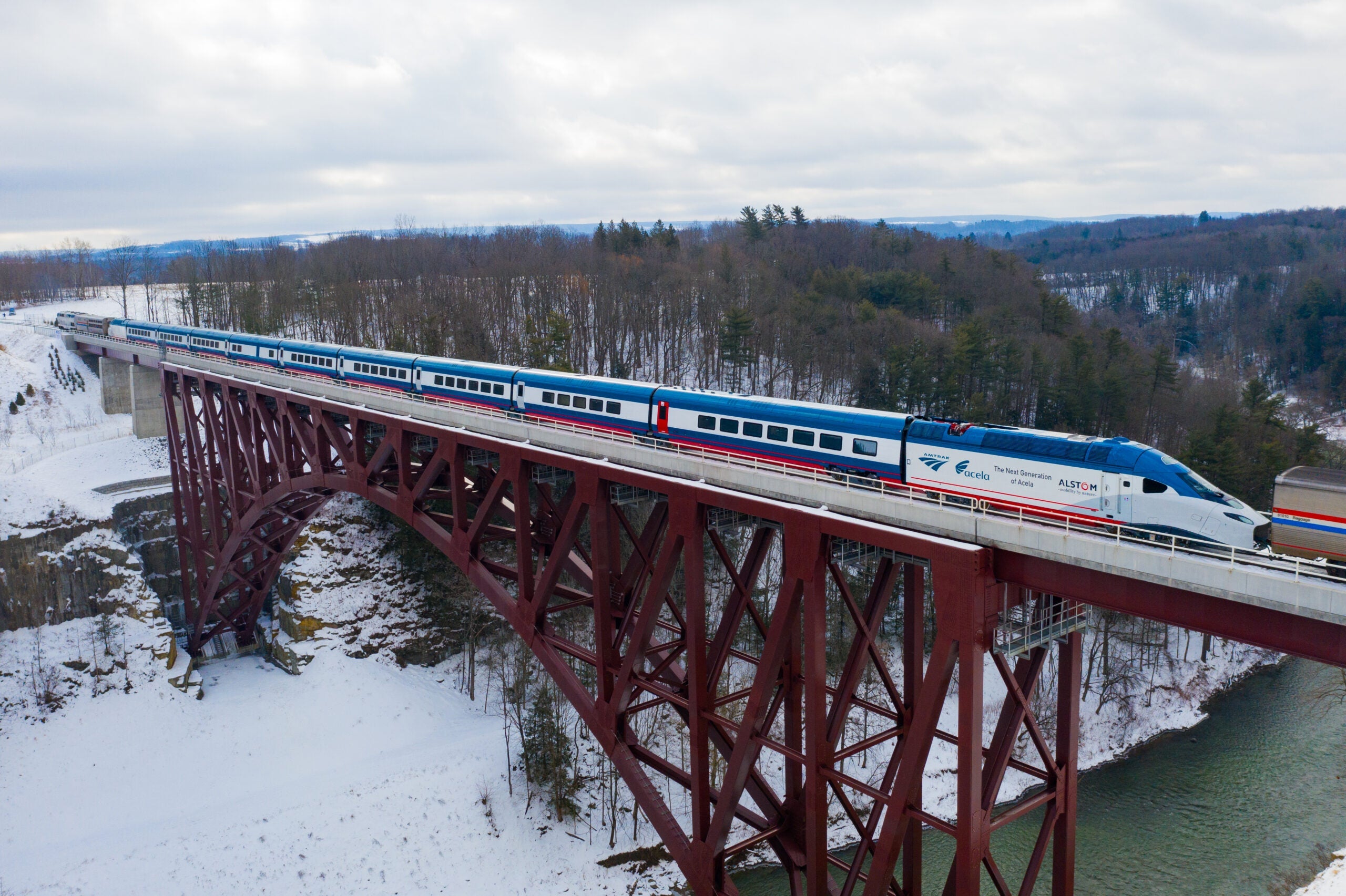 A train crosses a bridge in a snowy scenario