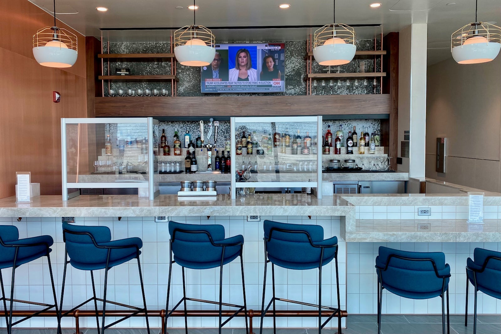 bar stools at a bar in an airport lounge