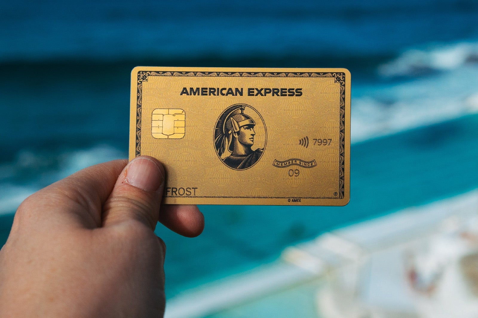 a hand holds a credit card