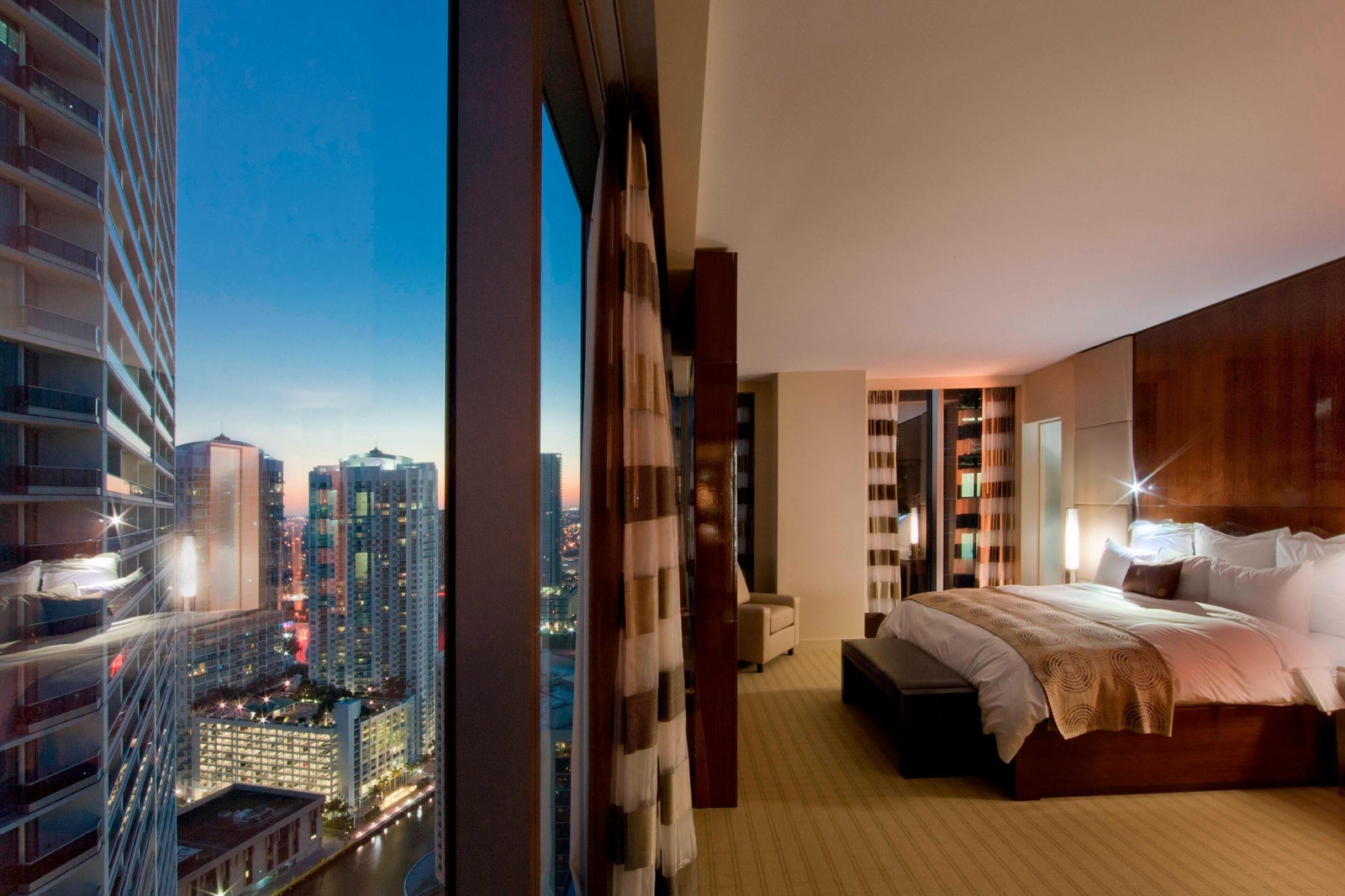a hotel room with a large window view to the outside world