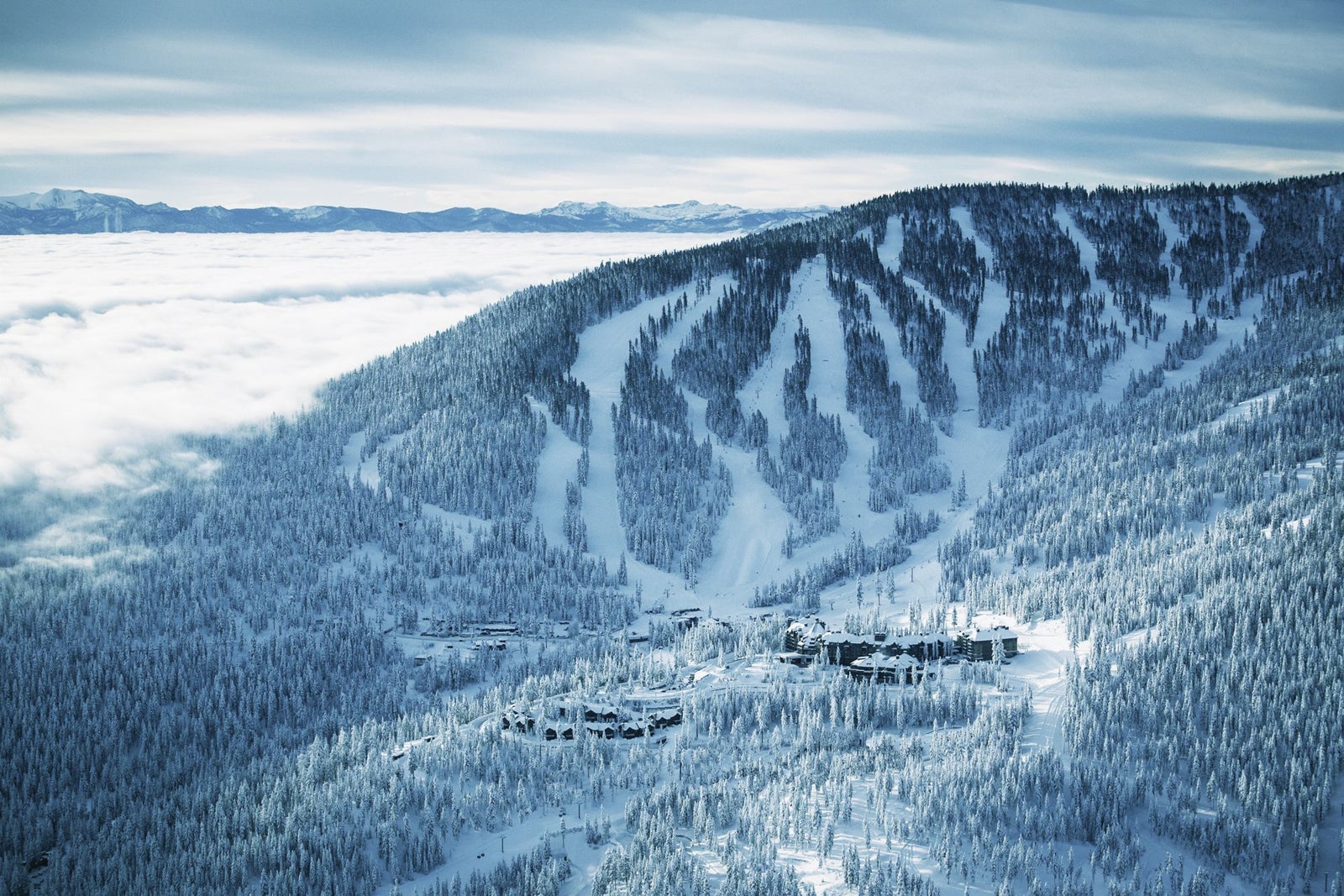 aerial view of resort and snowy mountain