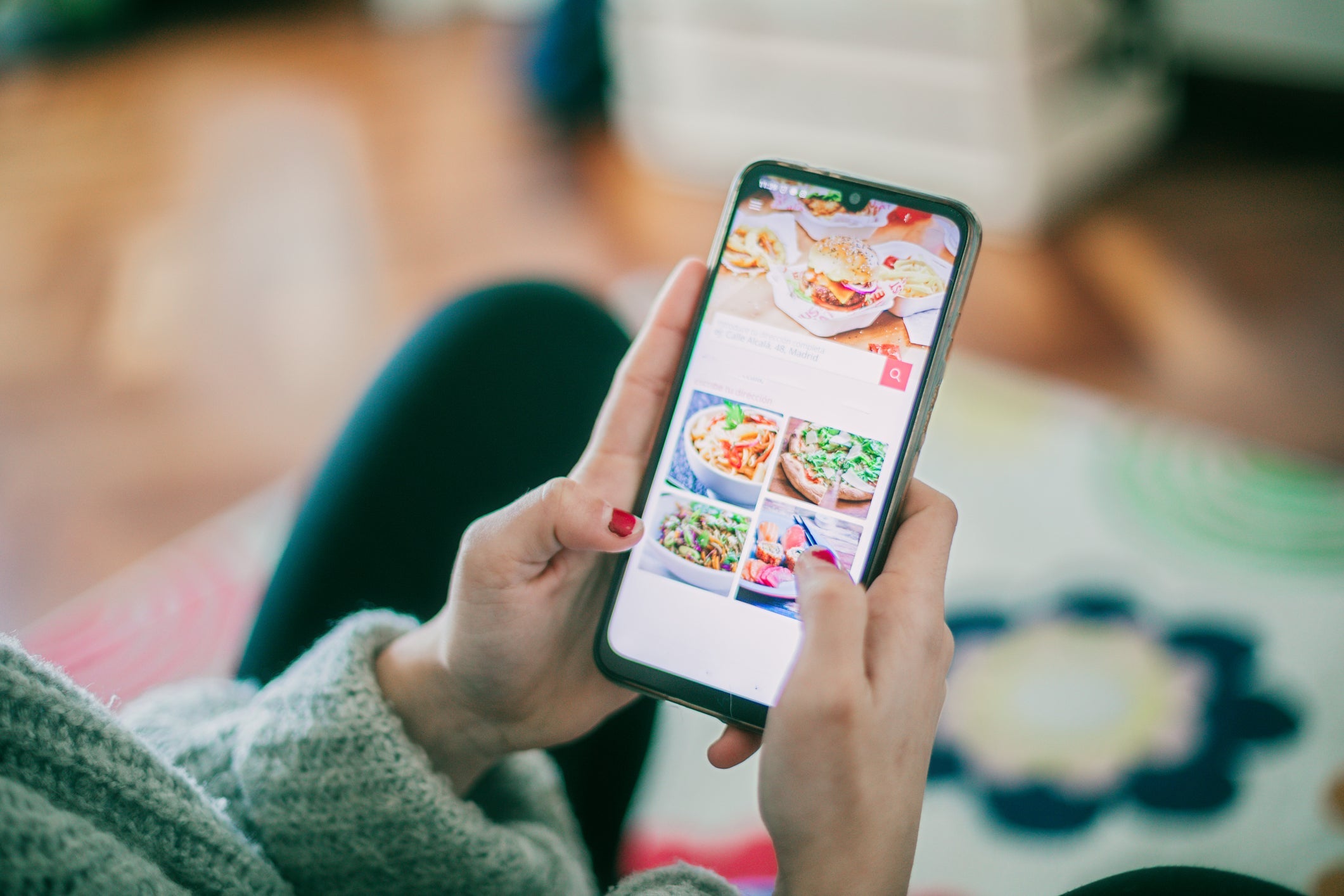 an unseen person uses an app to order food online