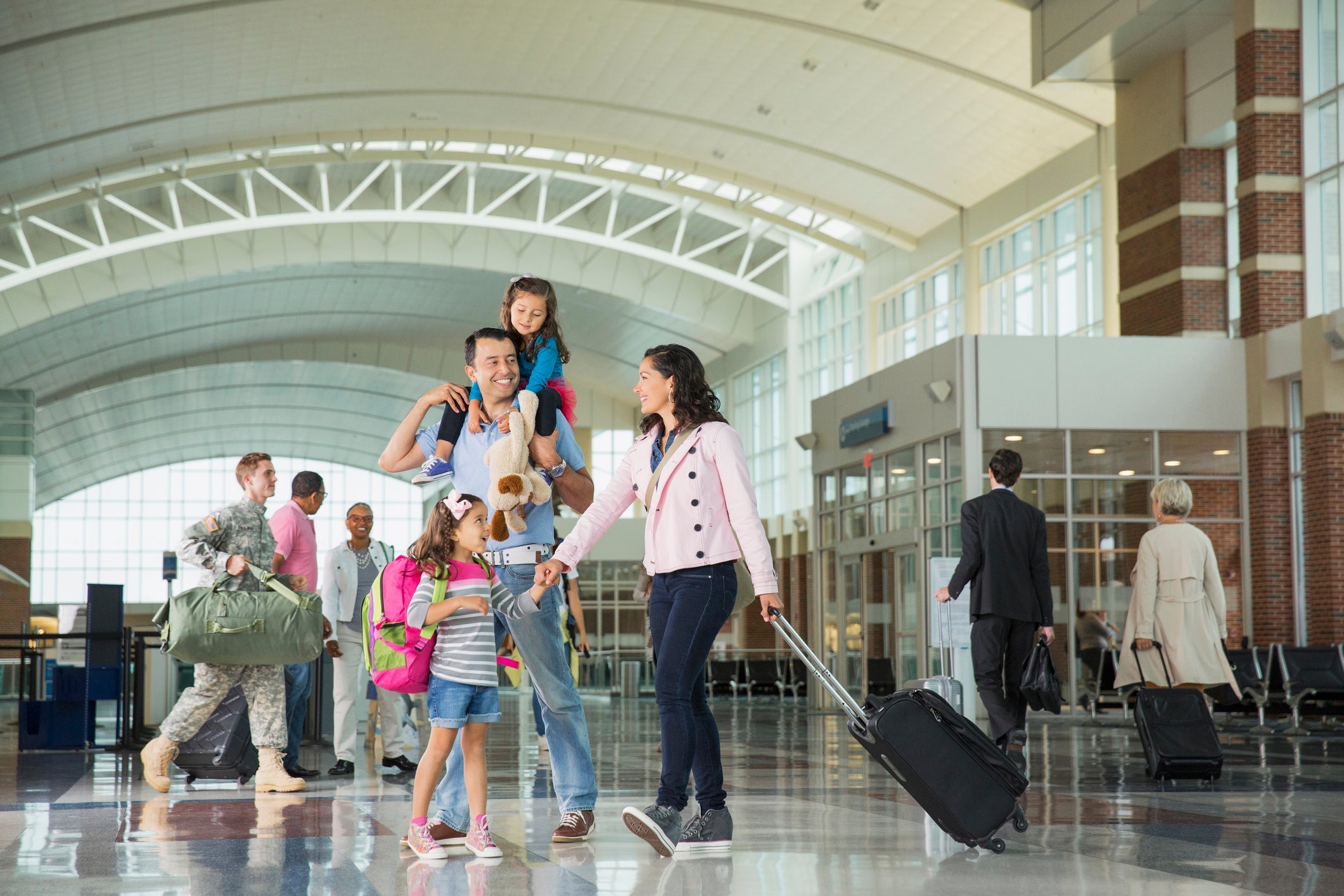 family with luggage airport