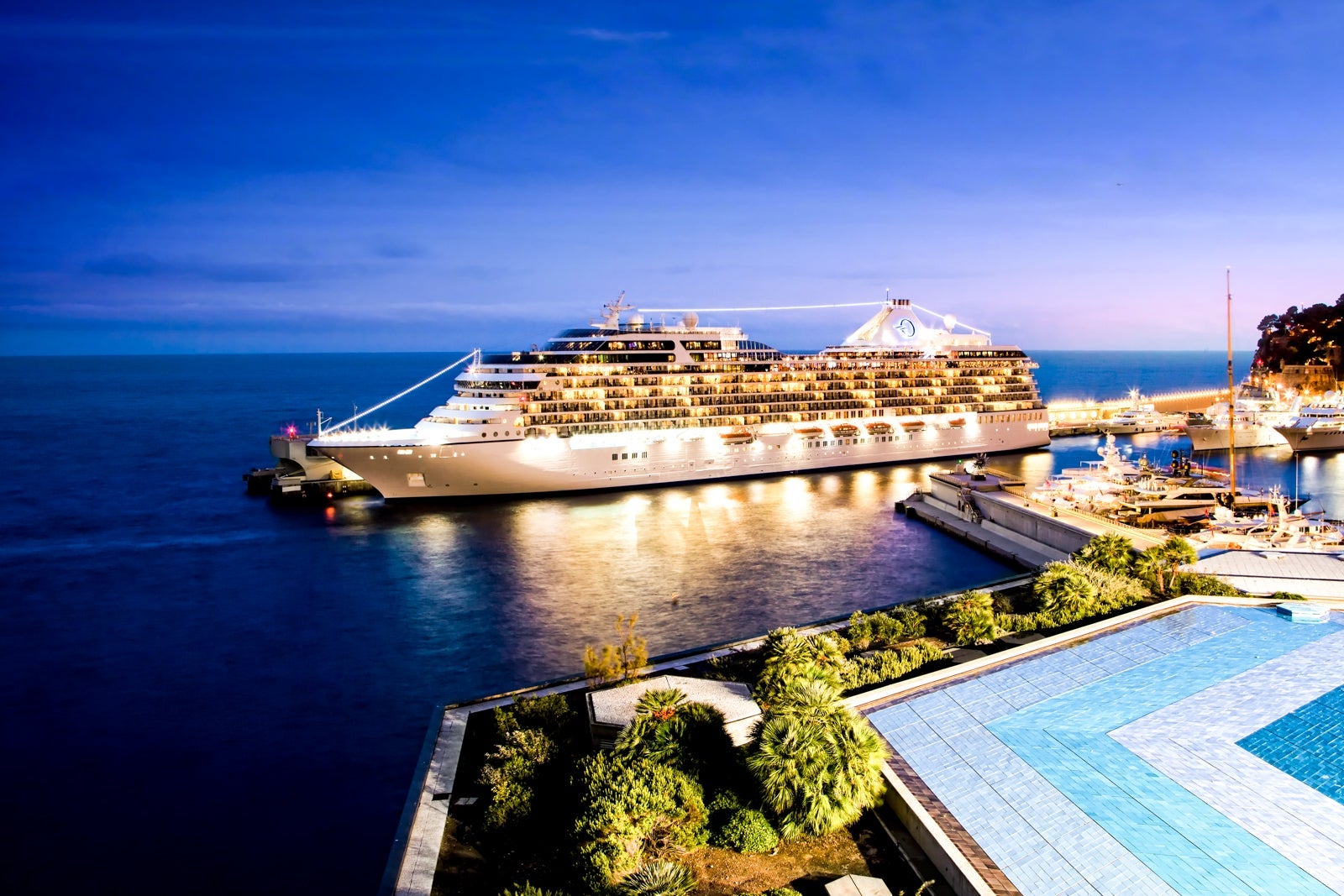 Oceania cruise ship docked in port at night