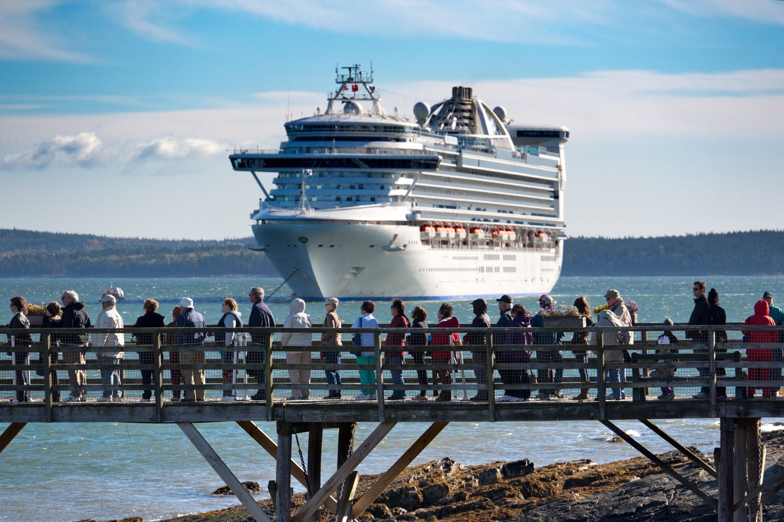 Cruise ship approaching passengers waiting in line