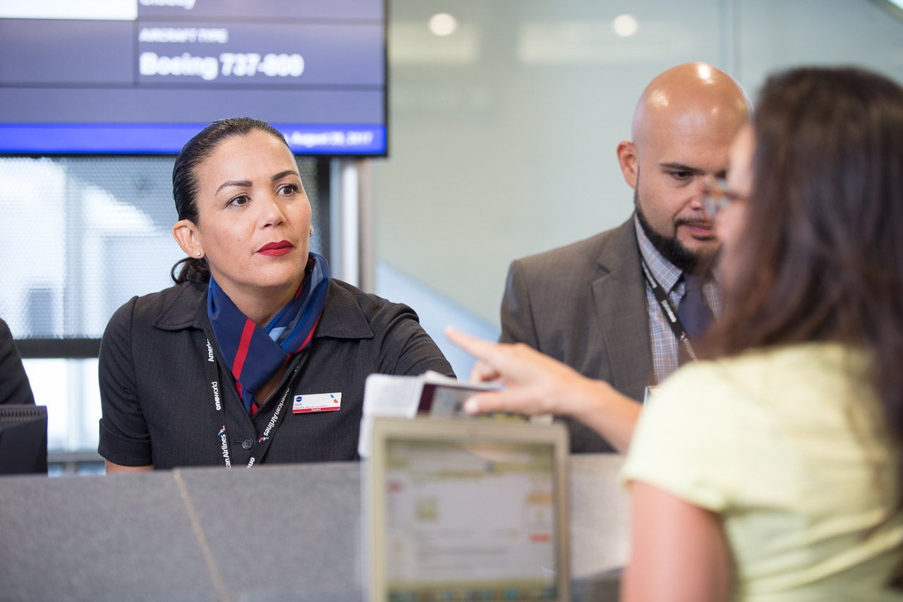 American Airlines gate agent helping customer