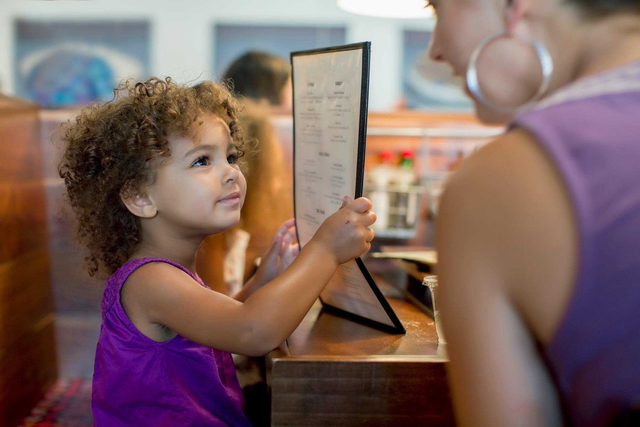 child ordering off restaurant menu
