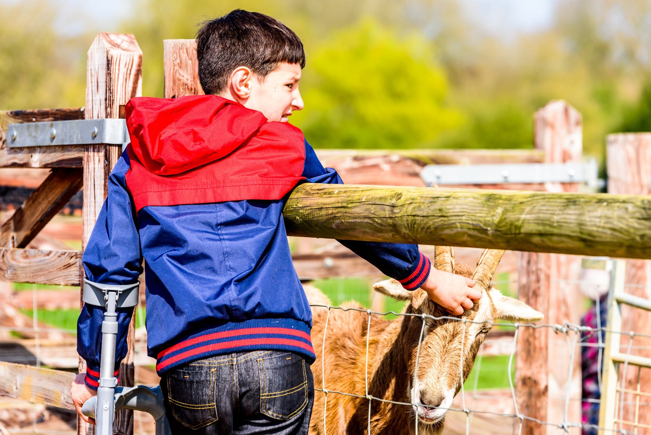 boy with crutch at farm