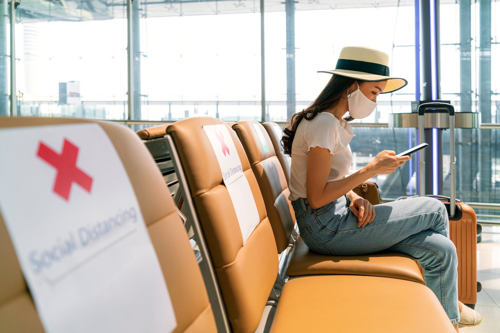 woman airport face mask social distance