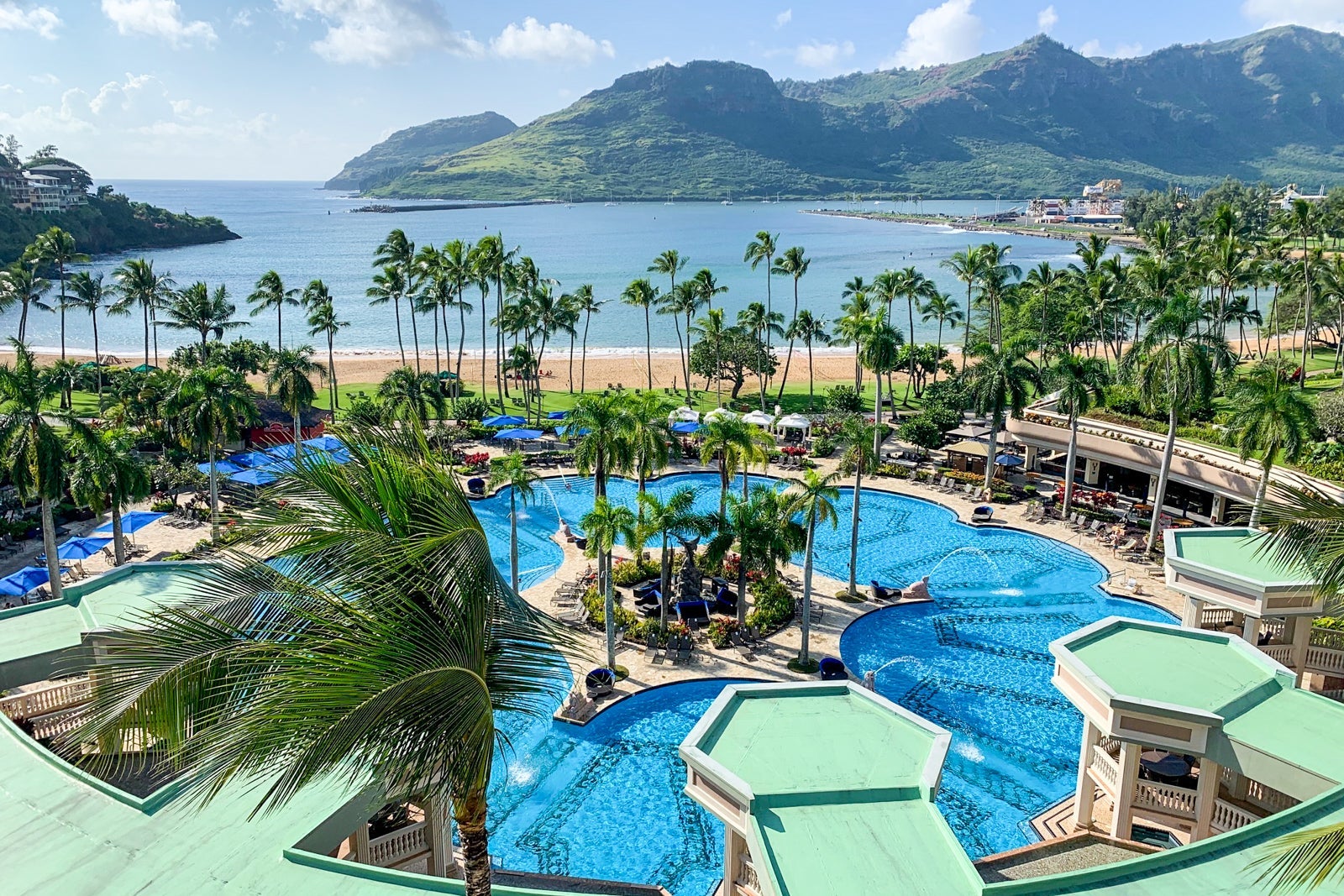 Image of a tropical Marriott resort with a pool and trees