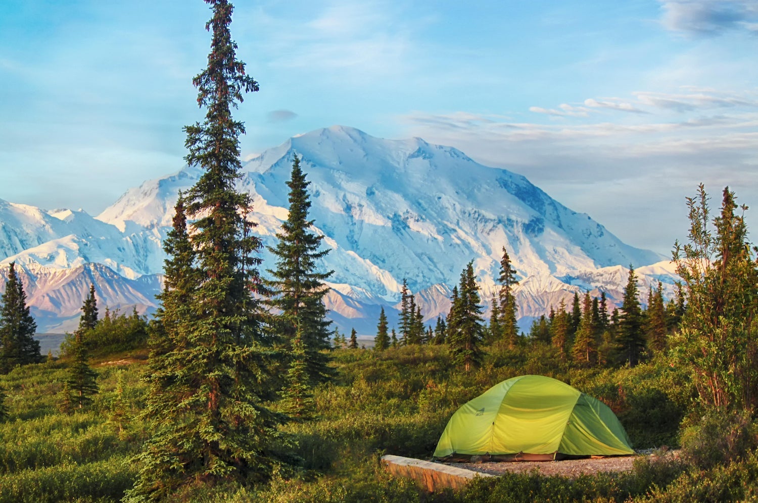 Tent camping at the wonder lake campground in Denali National Park. Denali is seen at back. Taken under the "midnight sun."