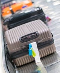 Suitcase or luggage with conveyor belt in the airport.
