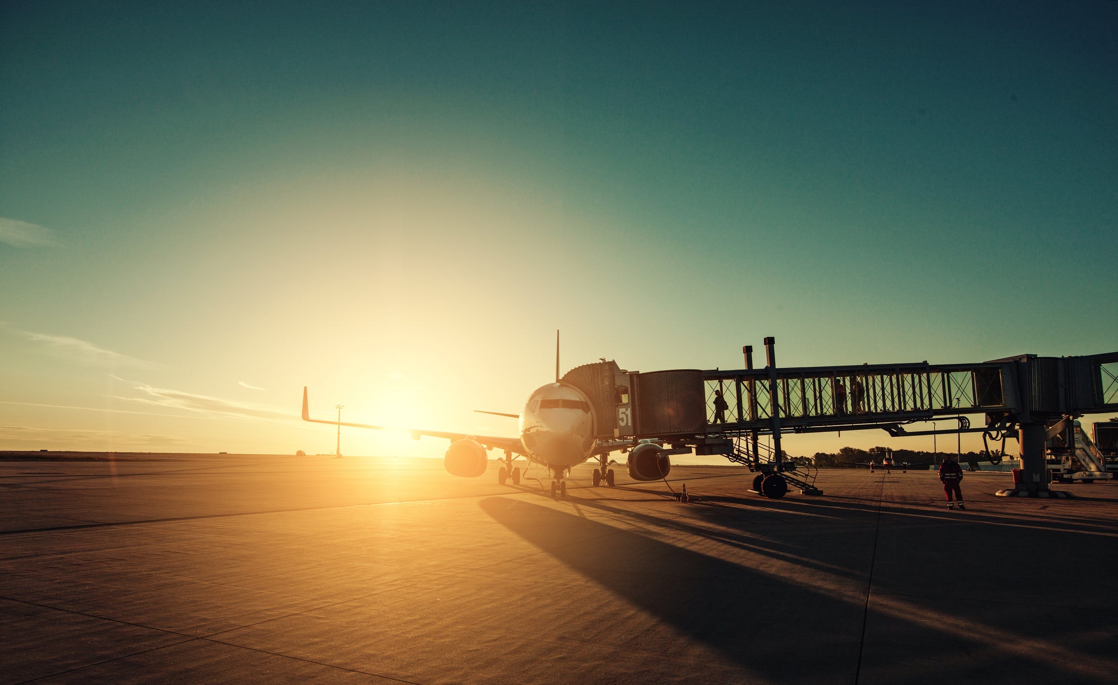 Airplane in airport runway during sunset