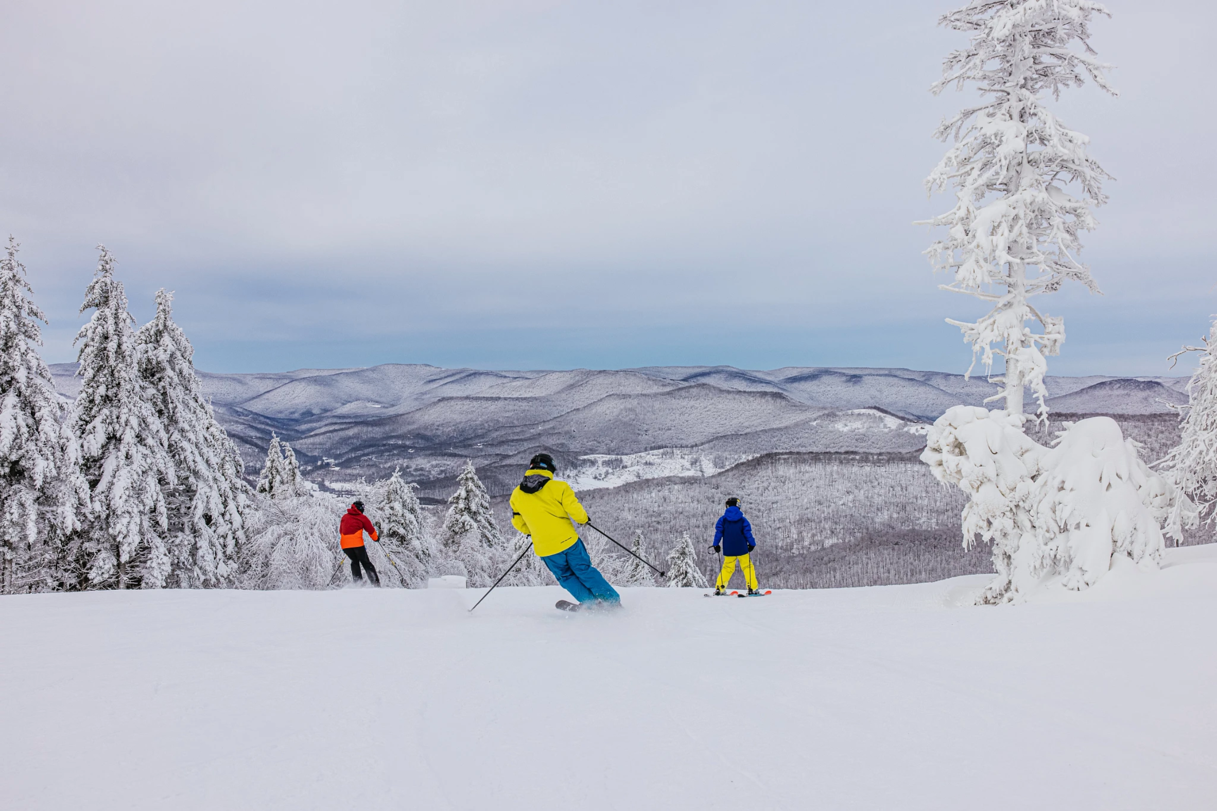 Skiers at the top of a trail on Snowshoe Mountain in West Virginia