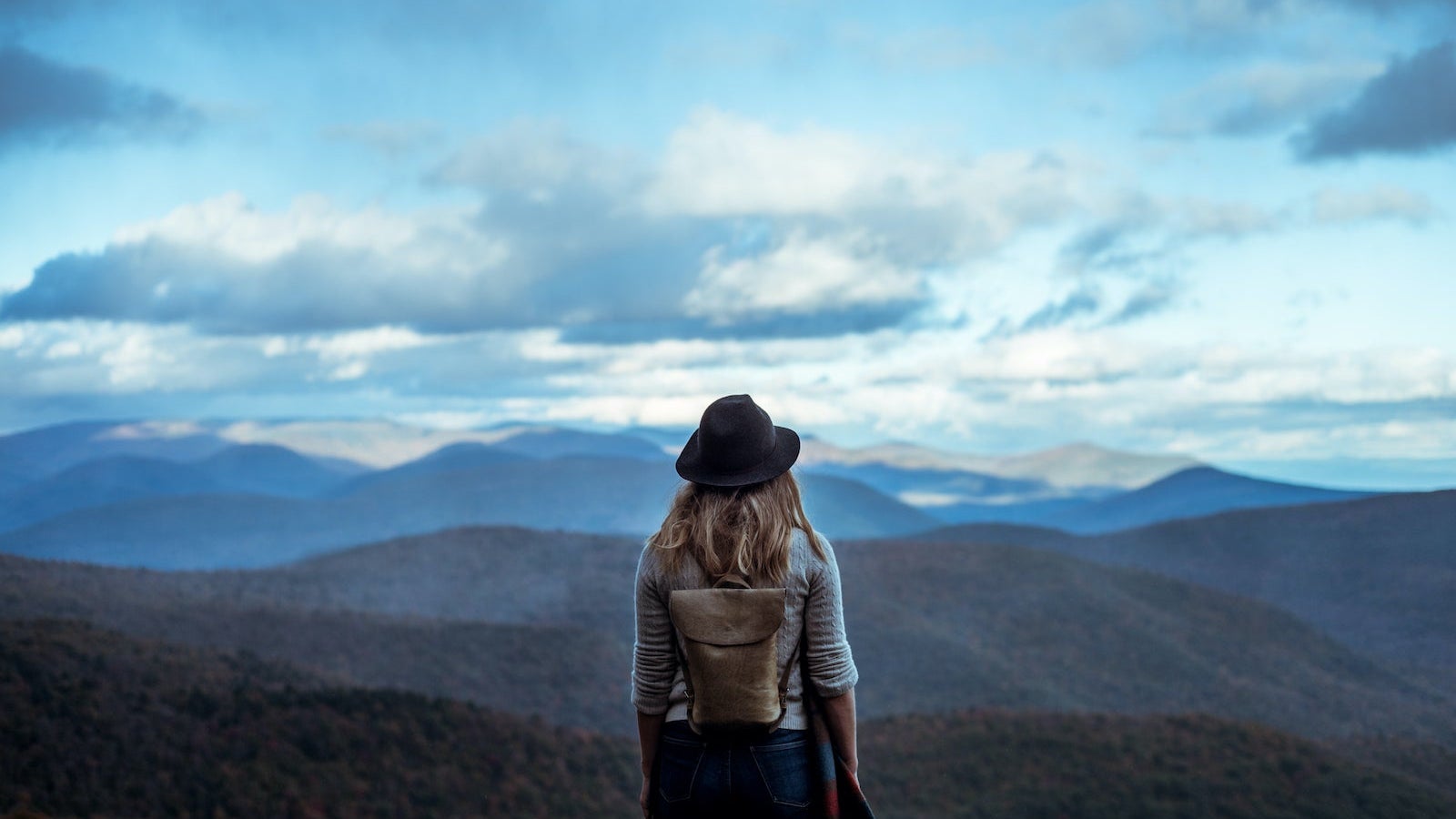 Young woman hiking through beautiful mountains.