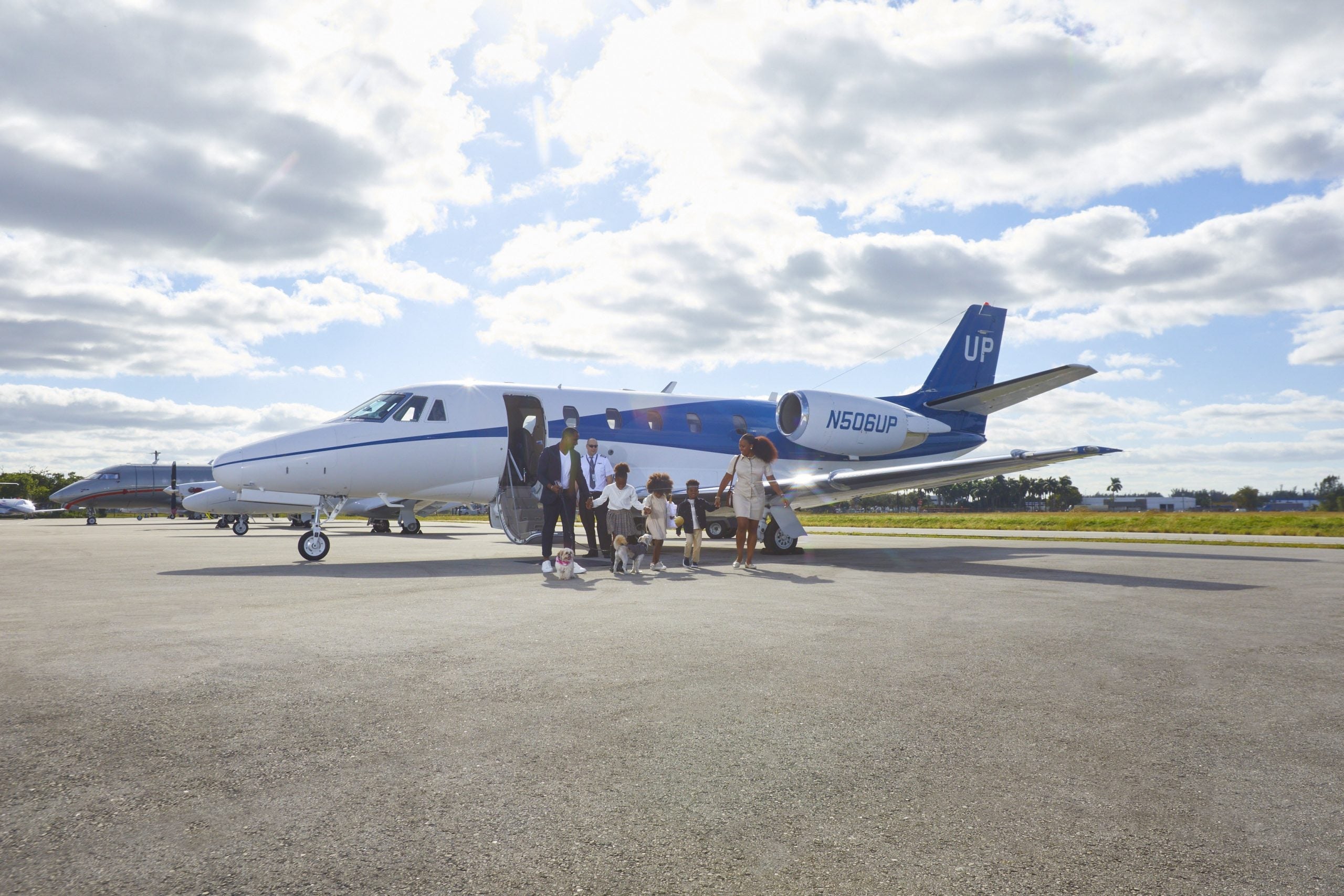 People boarding a Wheels Up plane