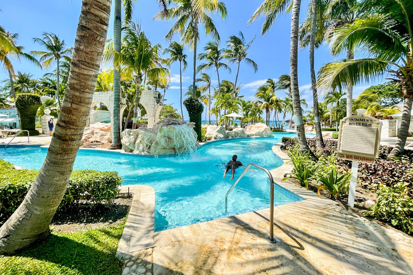 a person floats on a raft at a luxury hotel's lazy river