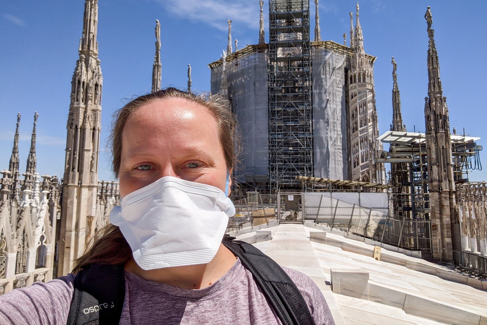 Katie Genter in mask on roof of Milan Cathedral