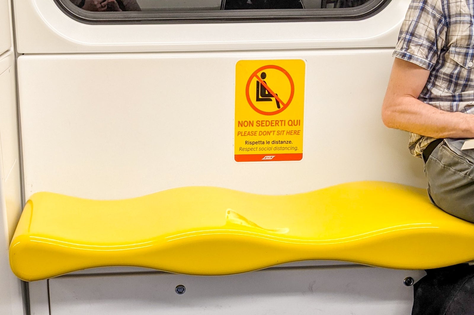 Milan metro seating sign for COVID-19 distancing