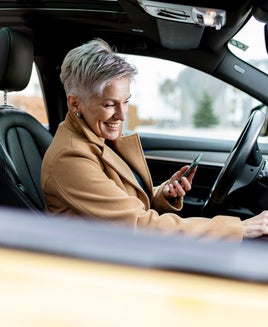 active women is using smart phone to start a sharing car