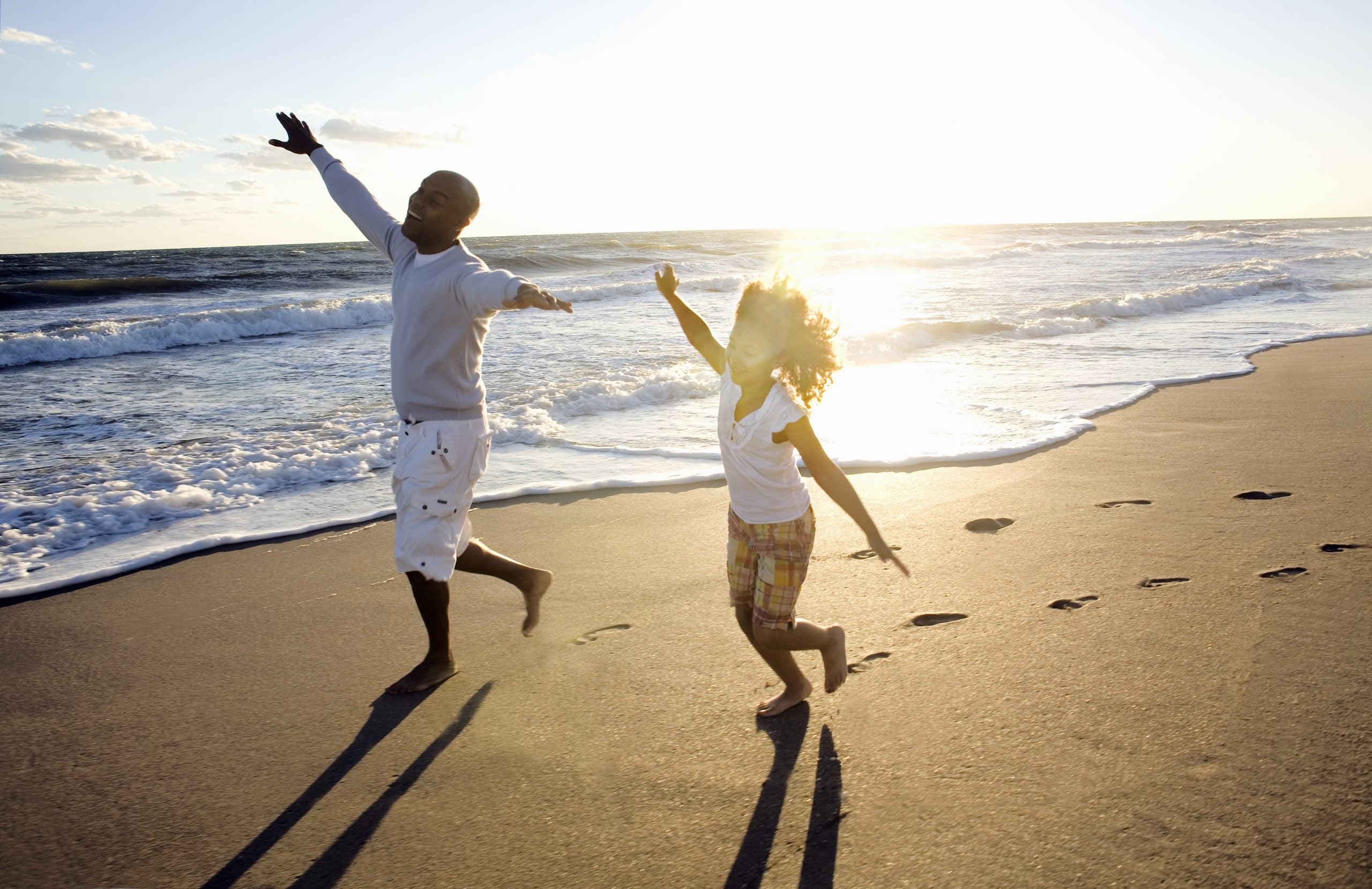 Father and daughter playing at beach
