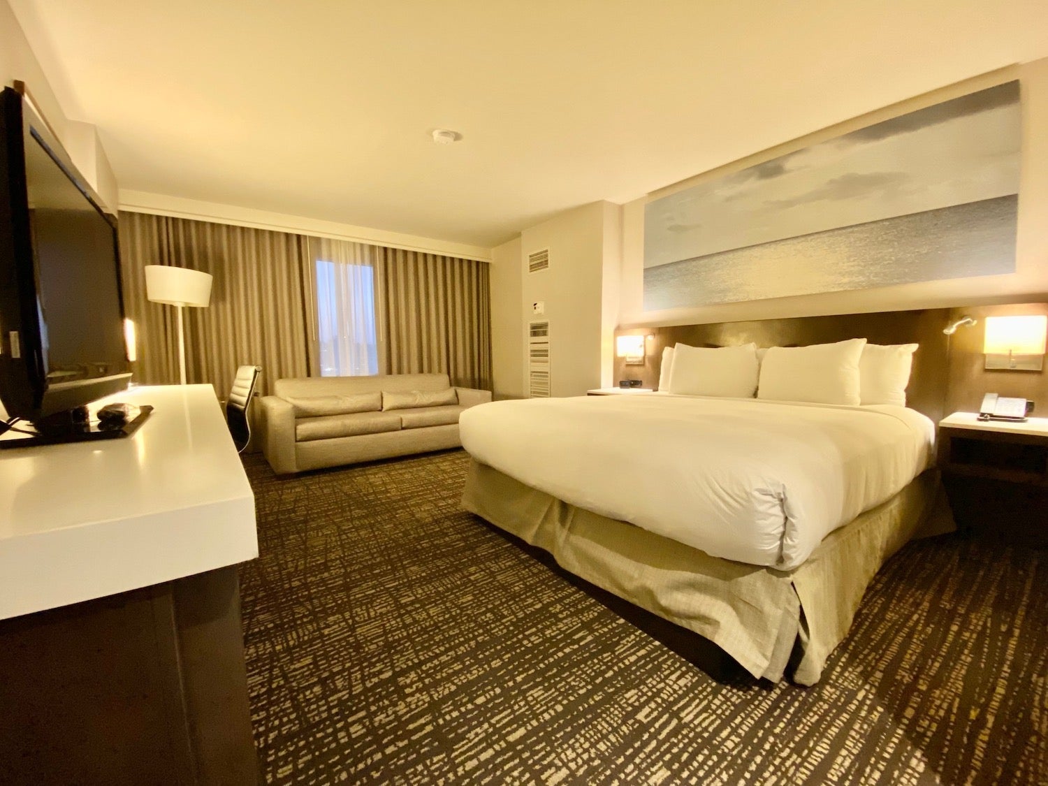 A room at the Hilton San Diego Mission Valley with a bed and couch near the window