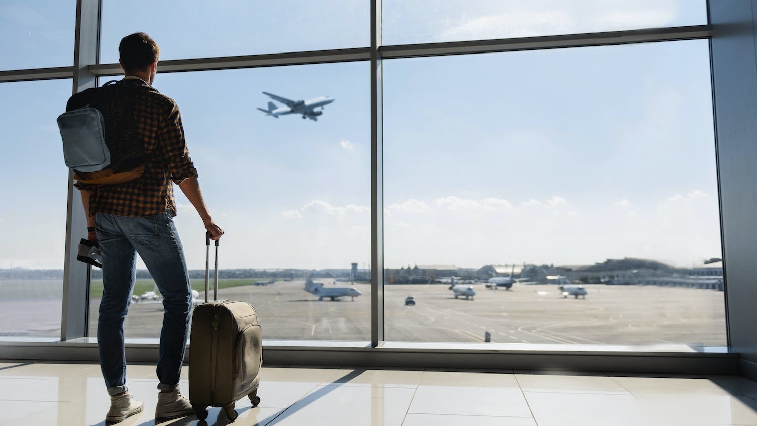 Man watching plane take off