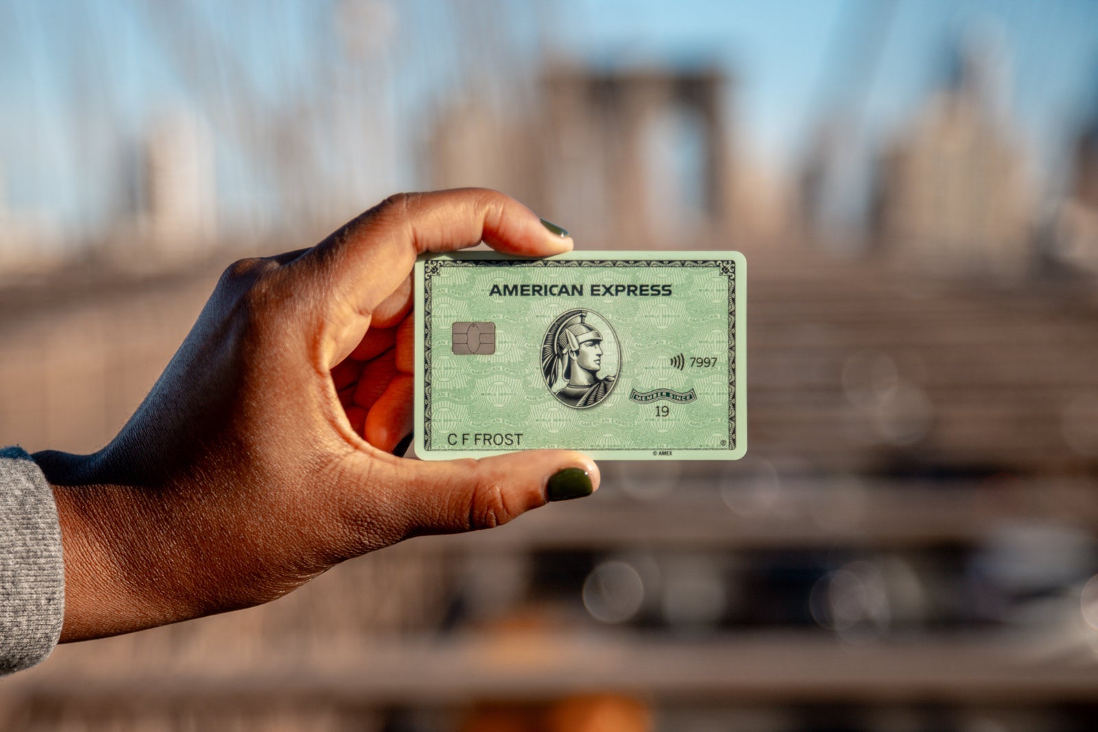 a hand holds a credit card
