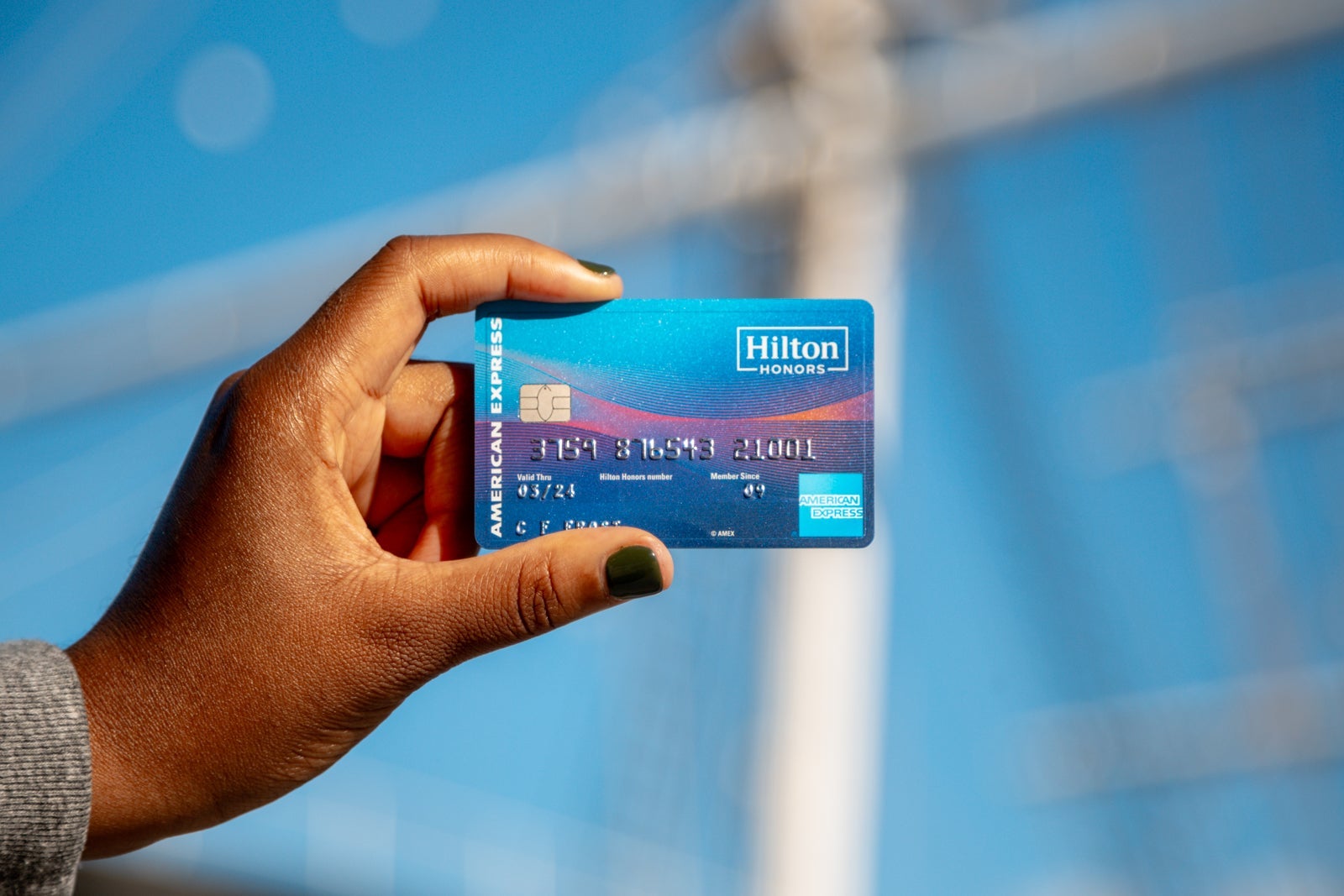 a hand holds a credit card