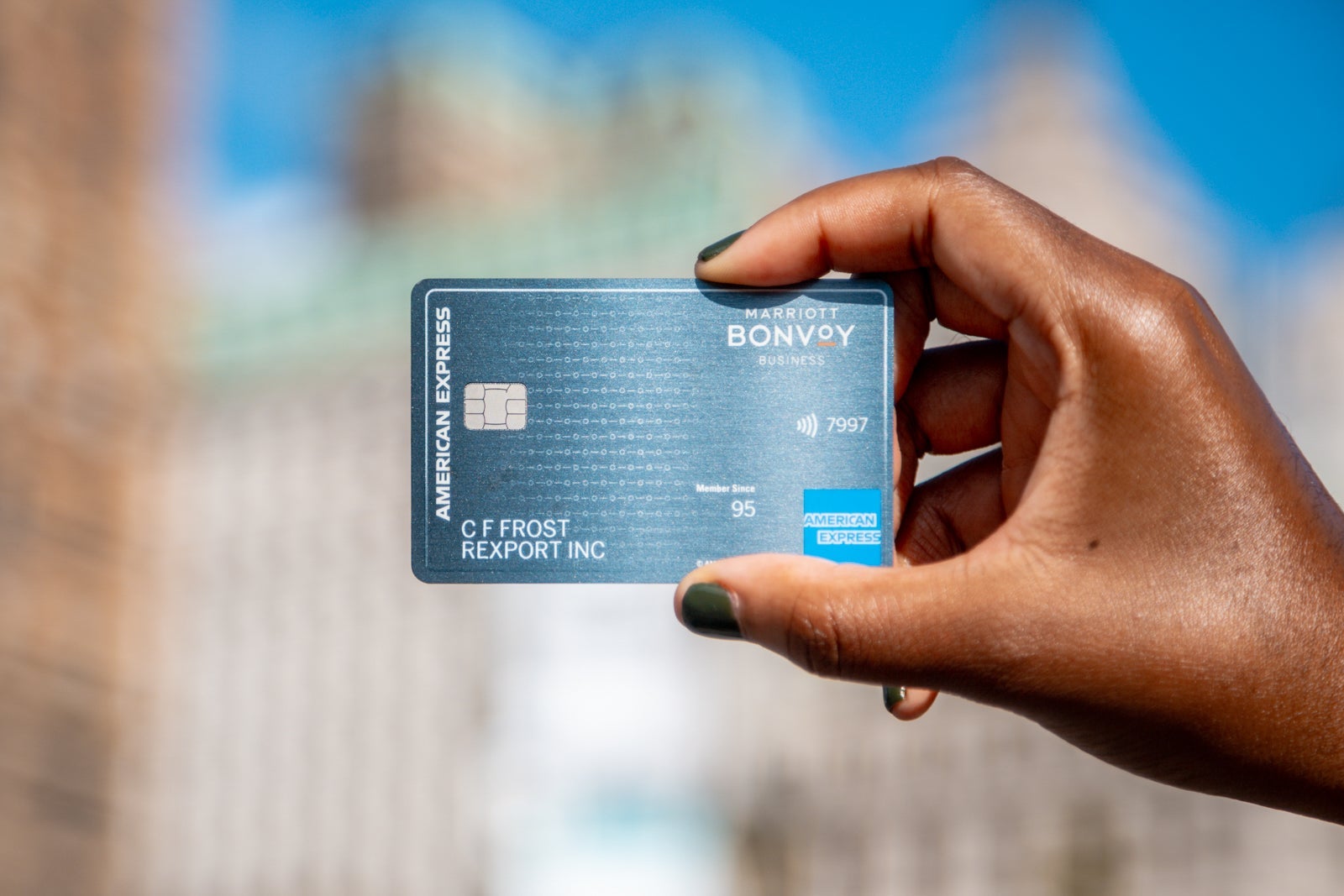 Photo of woman's hand holding Marriott Bonvoy Business Amex.