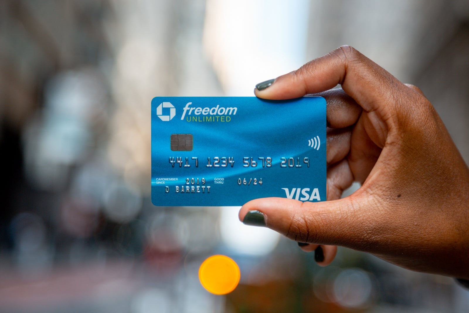 a hand holds a credit card