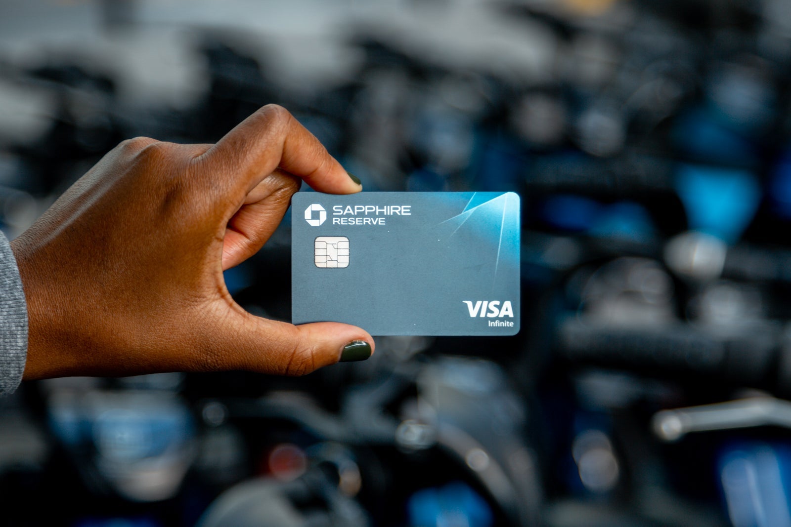 a hand holds a credit card